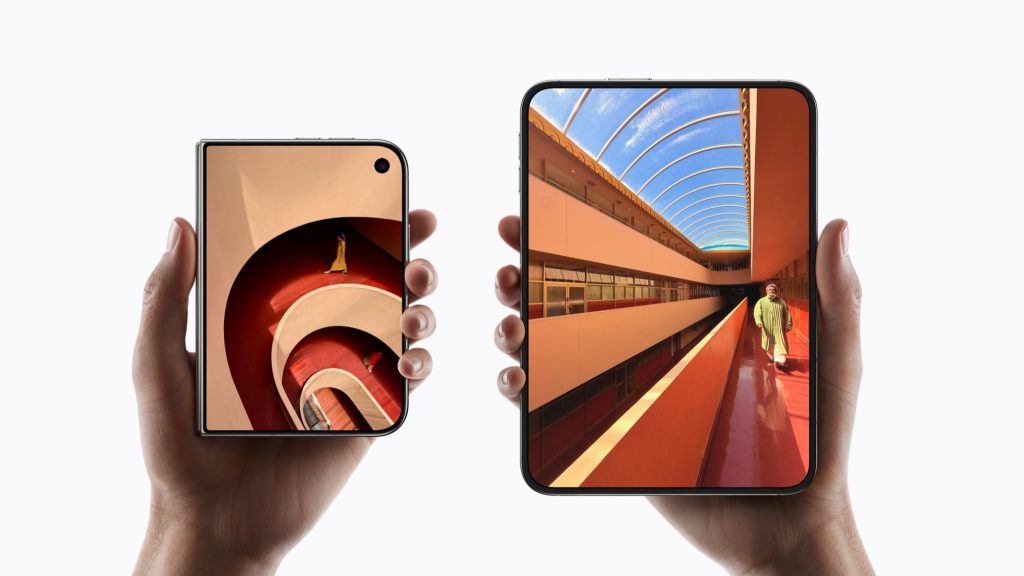 Two hands holding iPhone Duo, one closed like a small phone and one opened like a mini tablet