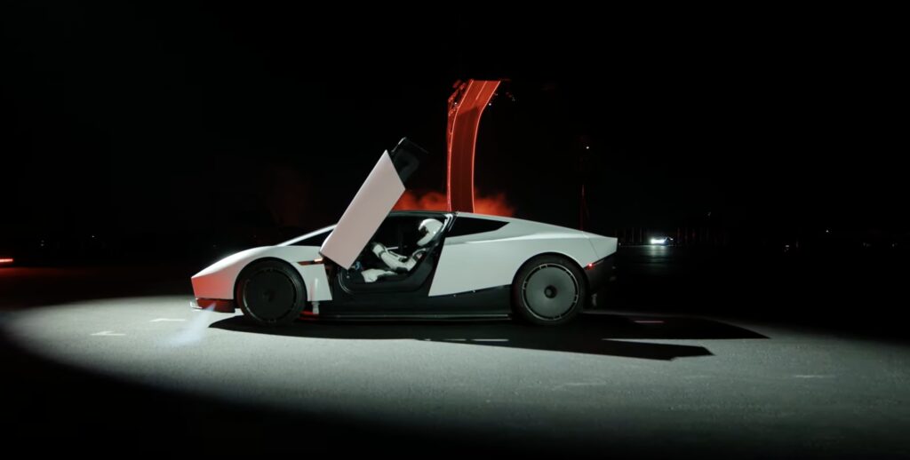 The new white Tesla Roadster in side view with its door open, at the October 2026 unveiling